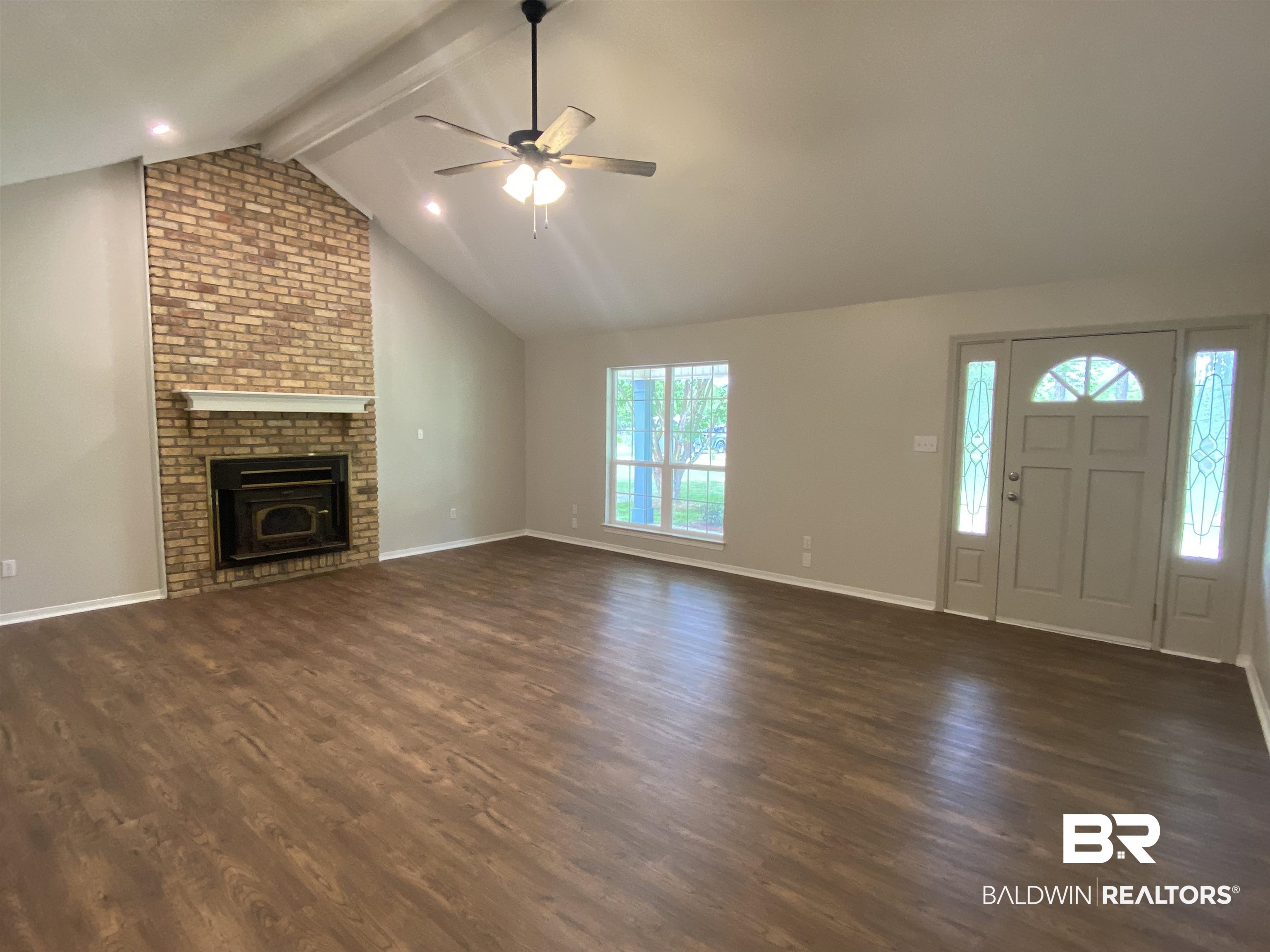 12150 Lee Bishop Road Irvington, AL 36544 - Photo 7 of 26 Unfurnished living room with a ceiling fan, baseboards, and dark wood-style floors