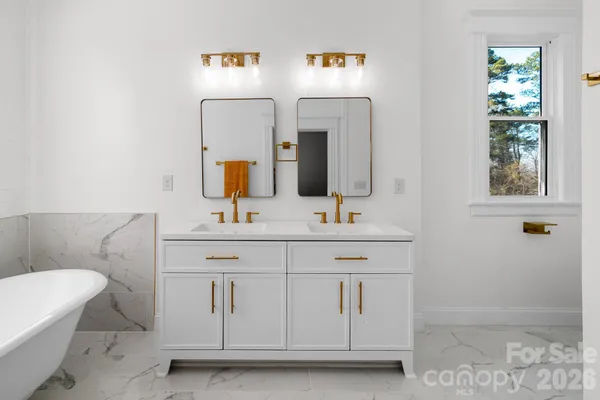 a bathroom with a sink vanity and mirror