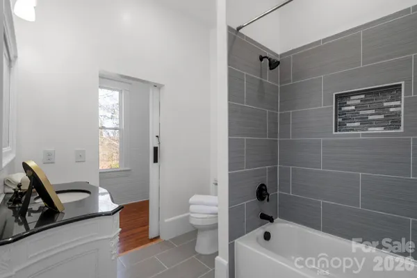 a bathroom with a bathtub and a shower
