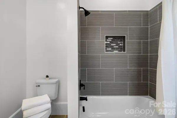 a bathroom with a toilet and bathtub
