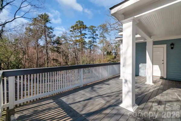 a view of a balcony with wooden floor