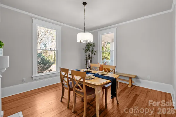 a view of a dining room with furniture window and wooden floor