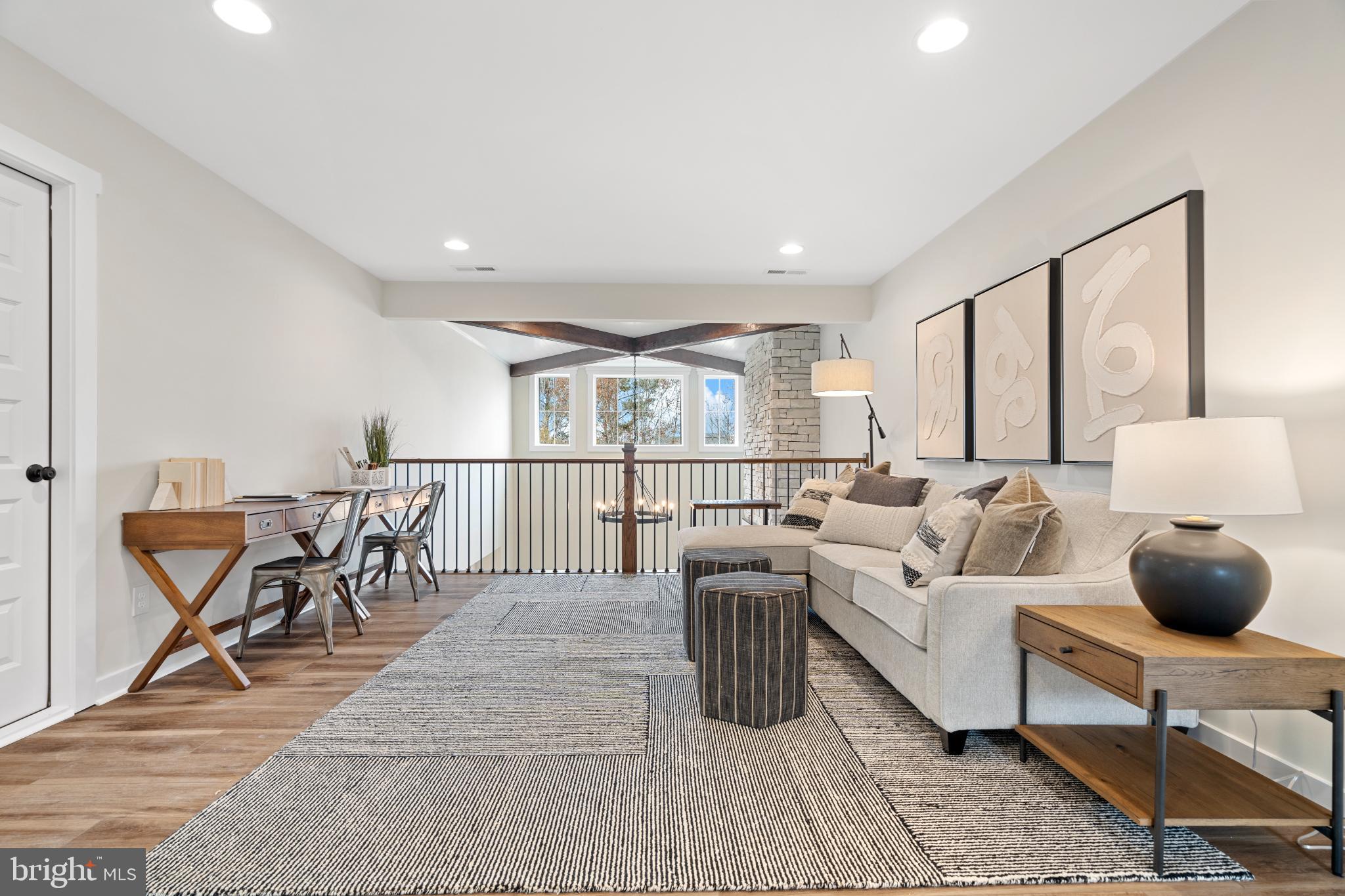 610 East Tolna Road, Unit SAVANNAH Shrewsbury, PA 17361 - Photo 12 of 19 a living room with furniture a wooden floor and a table
