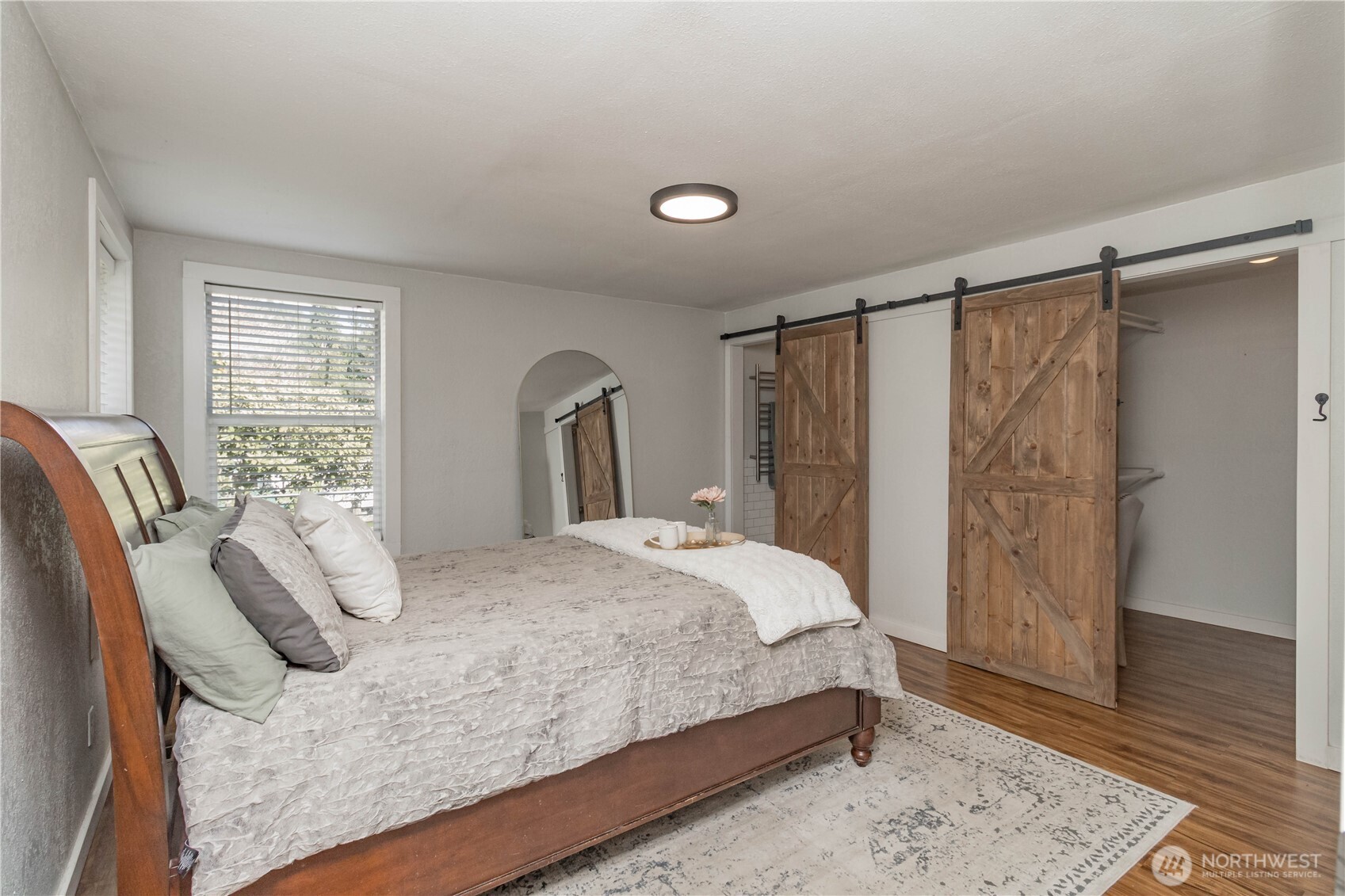 404 Factory Street Southeast Orting, WA 98360 - Photo 21 of 39 a bedroom with a bed and wooden floor
