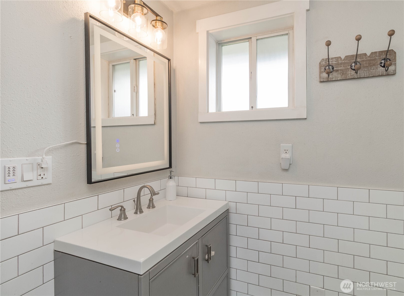 404 Factory Street Southeast Orting, WA 98360 - Photo 23 of 39 a bathroom with a sink vanity and mirror