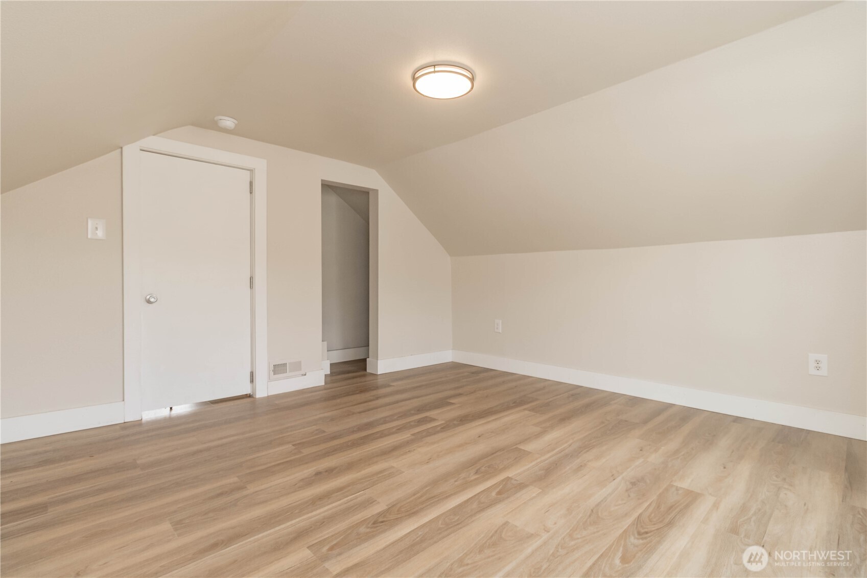404 Factory Street Southeast Orting, WA 98360 - Photo 27 of 39 a view of an empty room with wooden floor