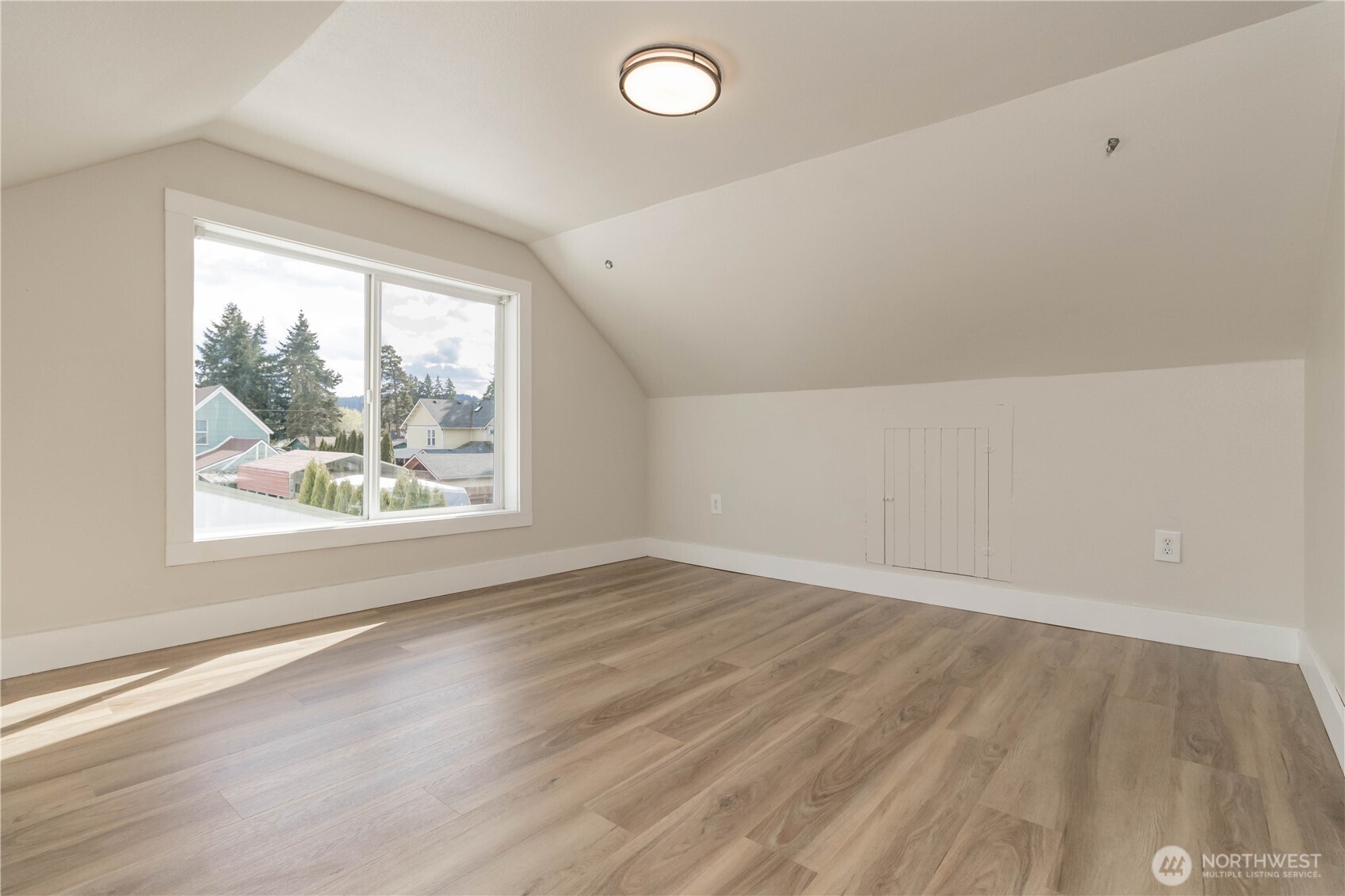 404 Factory Street Southeast Orting, WA 98360 - Photo 29 of 39 an empty room with wooden floor and windows