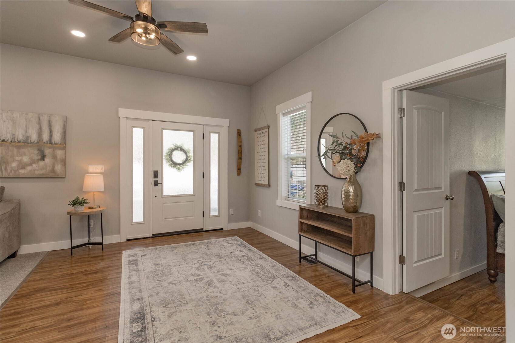 404 Factory Street Southeast Orting, WA 98360 - Photo 5 of 39 a view of a hallway with wooden floor and a large window