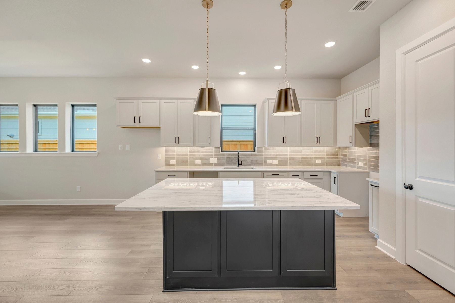 2722 Cottage Place Rosharon, TX 77583 - Photo 23 of 50 a large kitchen with kitchen island a sink stainless steel appliances and white cabinets