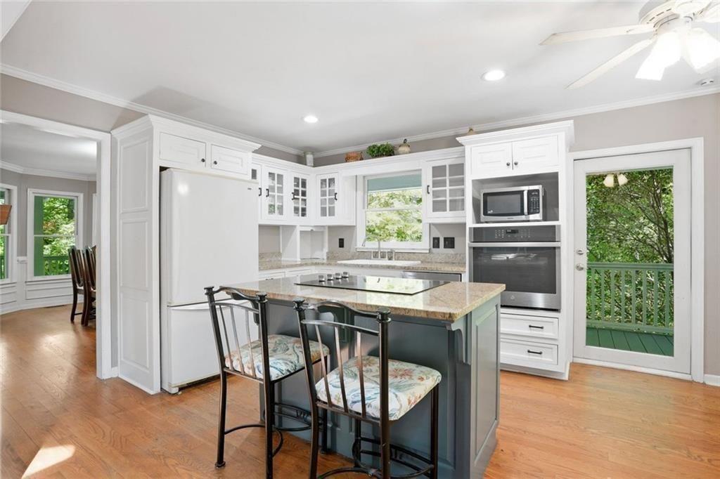 3259 Etchison Road Loganville, GA 30052 - Photo 14 of 50 a kitchen with stainless steel appliances a table chairs and a refrigerator