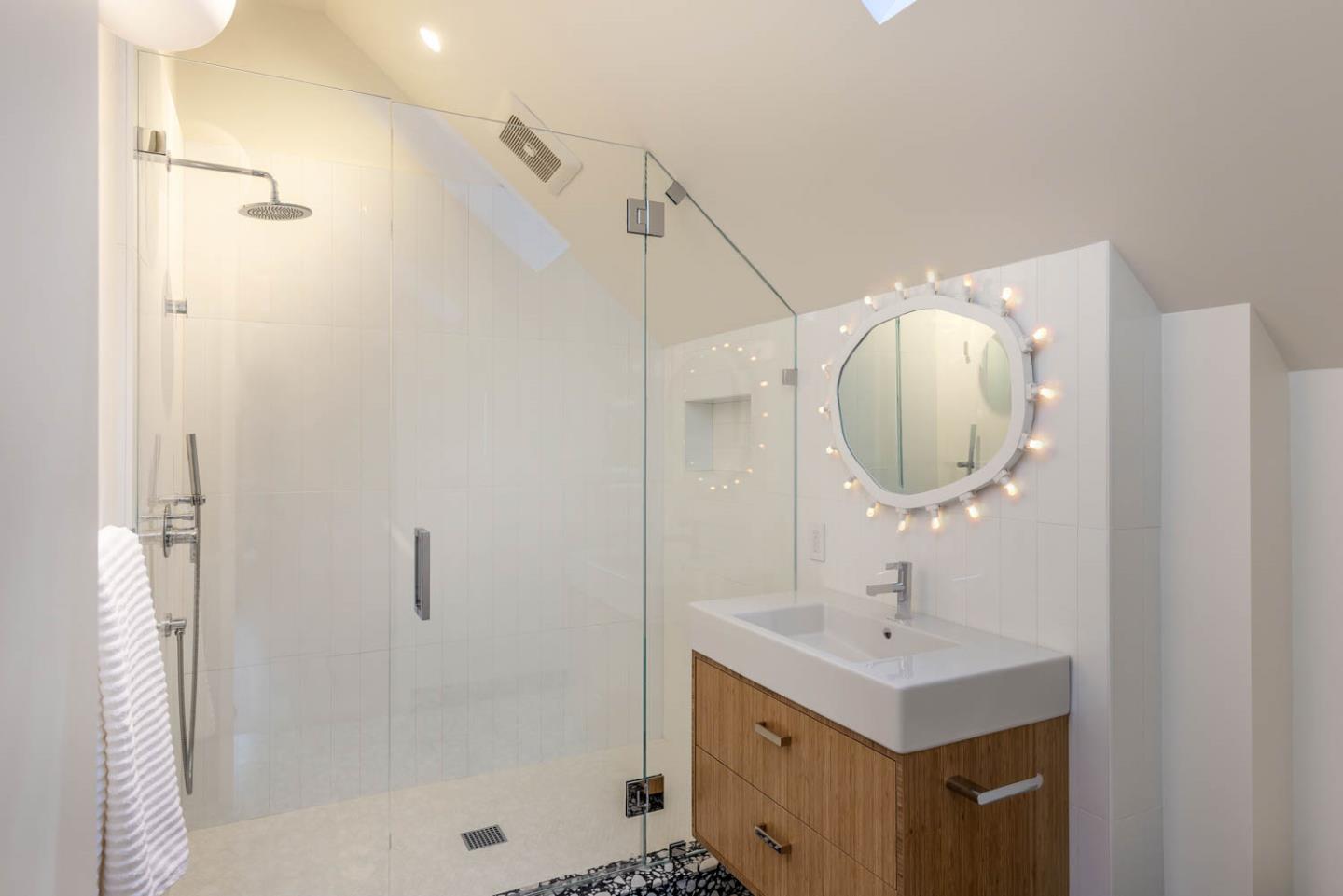 3450 Tripp Road Woodside, CA 94062 - Photo 16 of 27 a bathroom with a sink a light fixture and a mirror
