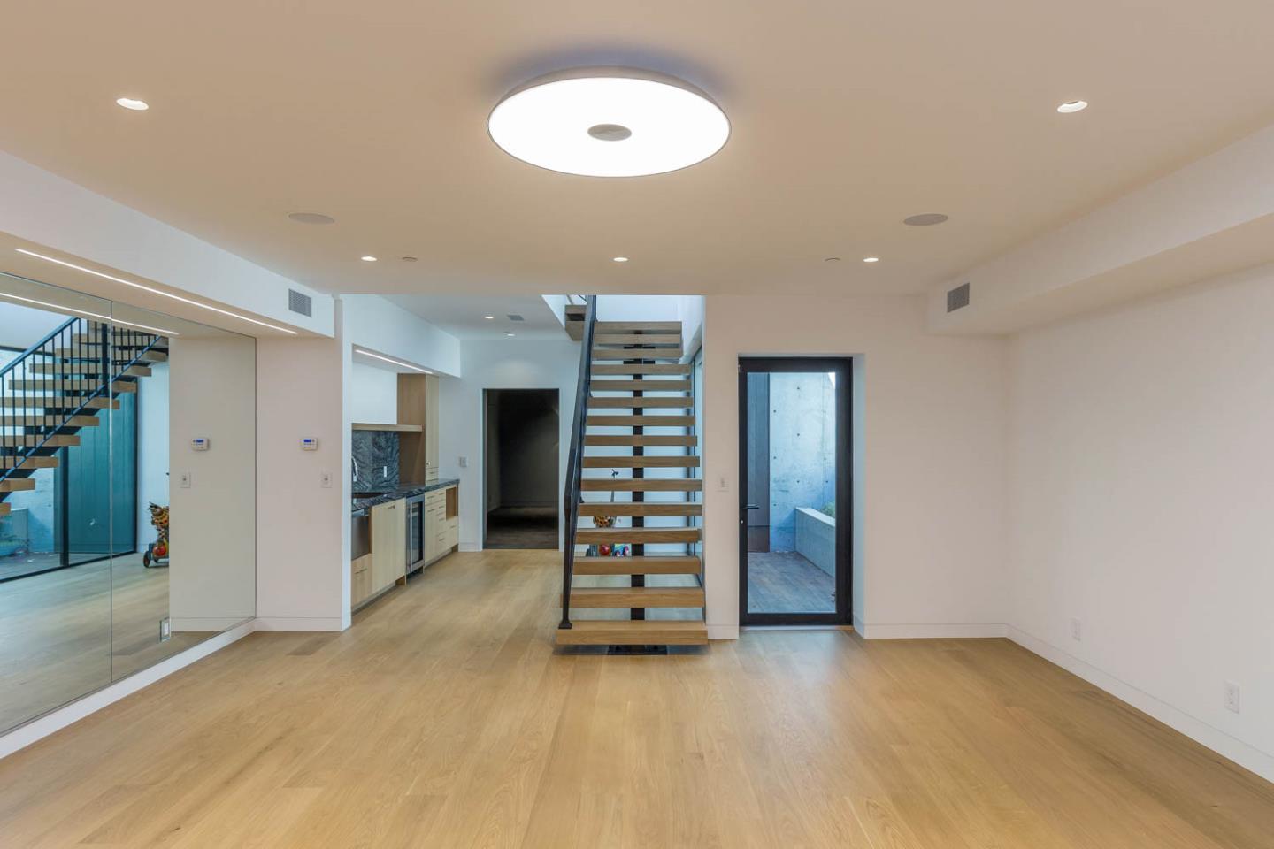 3450 Tripp Road Woodside, CA 94062 - Photo 19 of 27 an empty room with wooden floor and windows