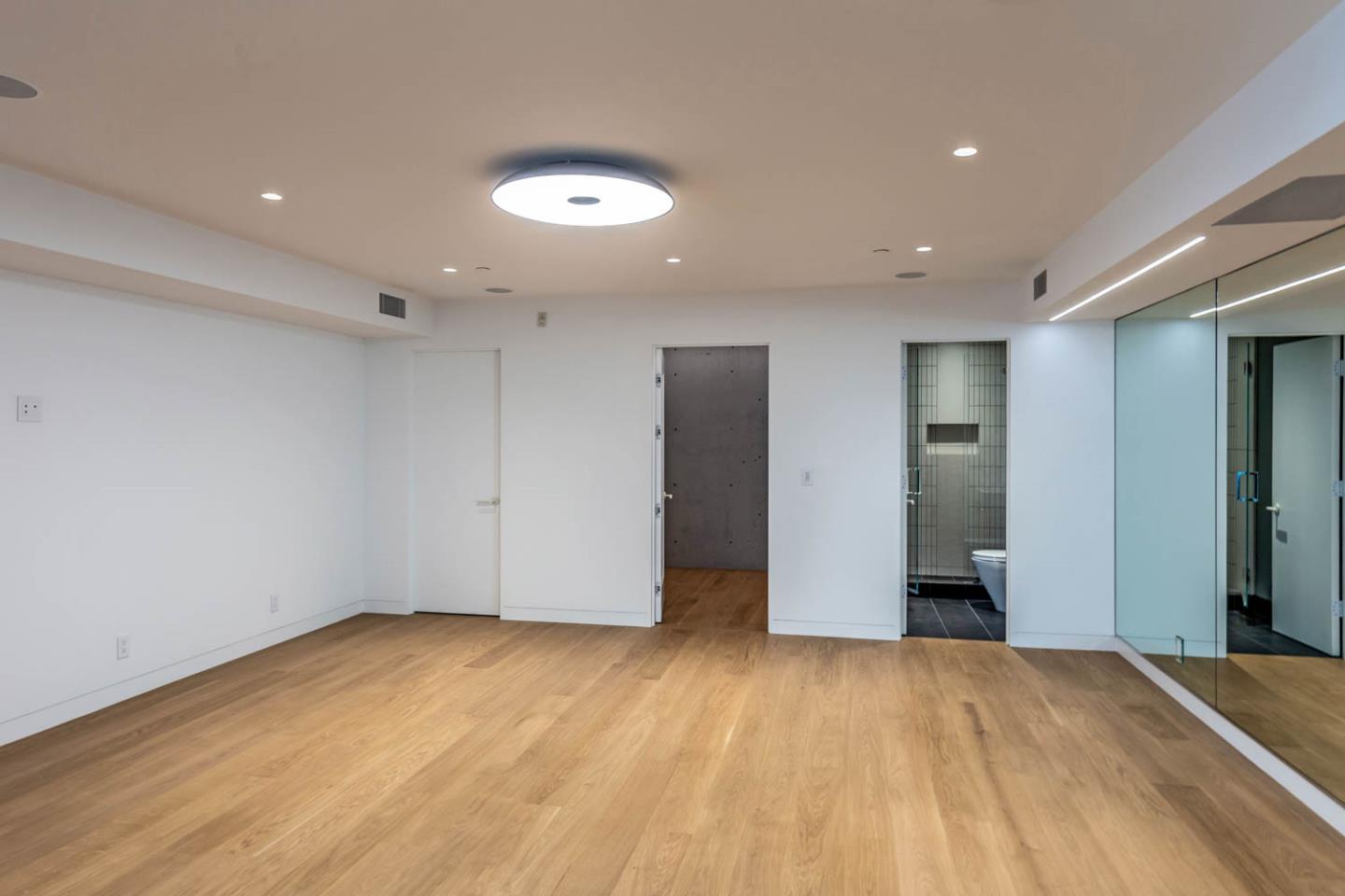 3450 Tripp Road Woodside, CA 94062 - Photo 21 of 27 an empty room with wooden floor and bathroom