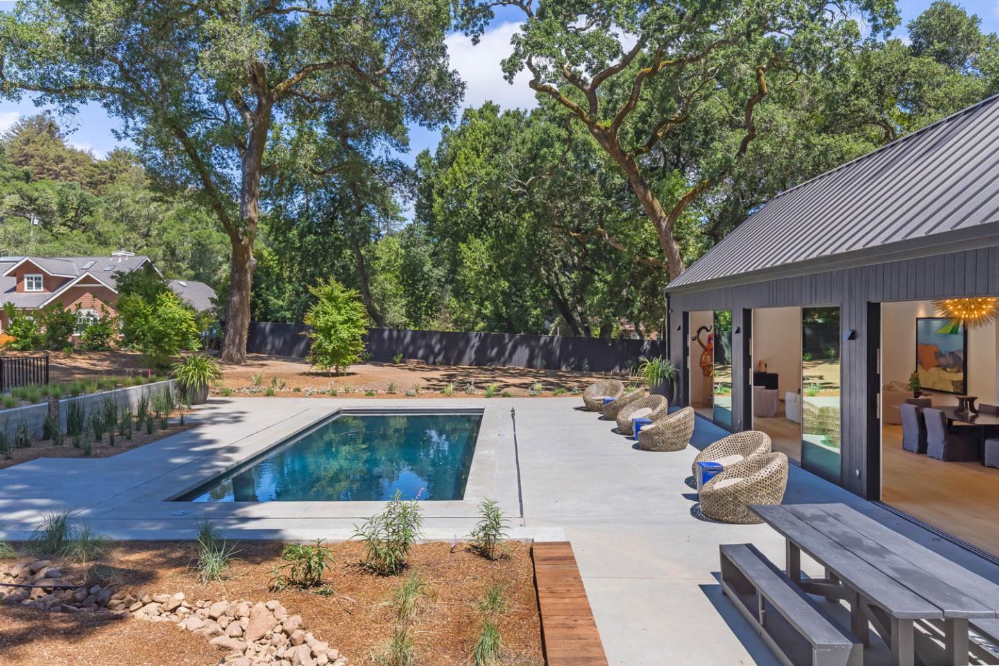 3450 Tripp Road Woodside, CA 94062 - Photo 23 of 27 a view of a swimming pool with chairs in patio