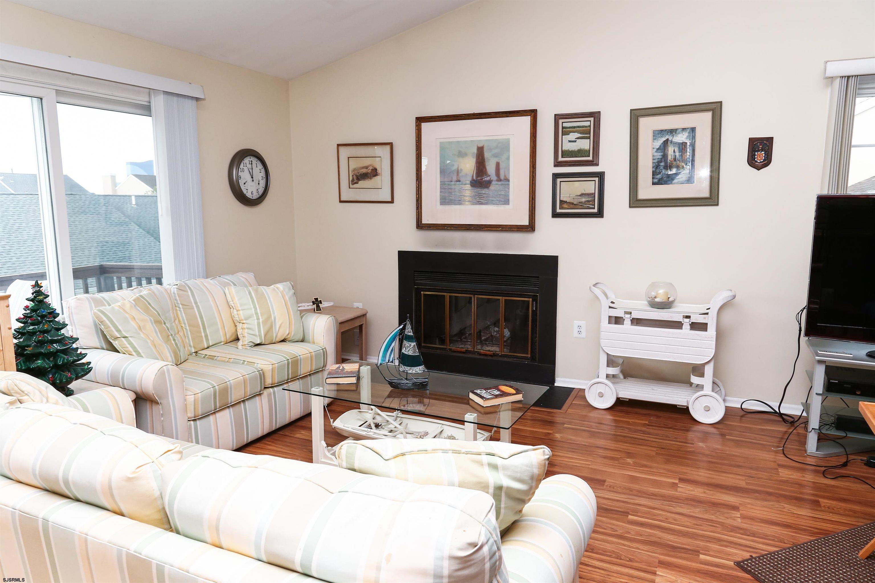 340 Seashell Lane Brigantine, NJ 08203 - Photo 18 of 29 a living room with furniture a flat screen tv and a fireplace
