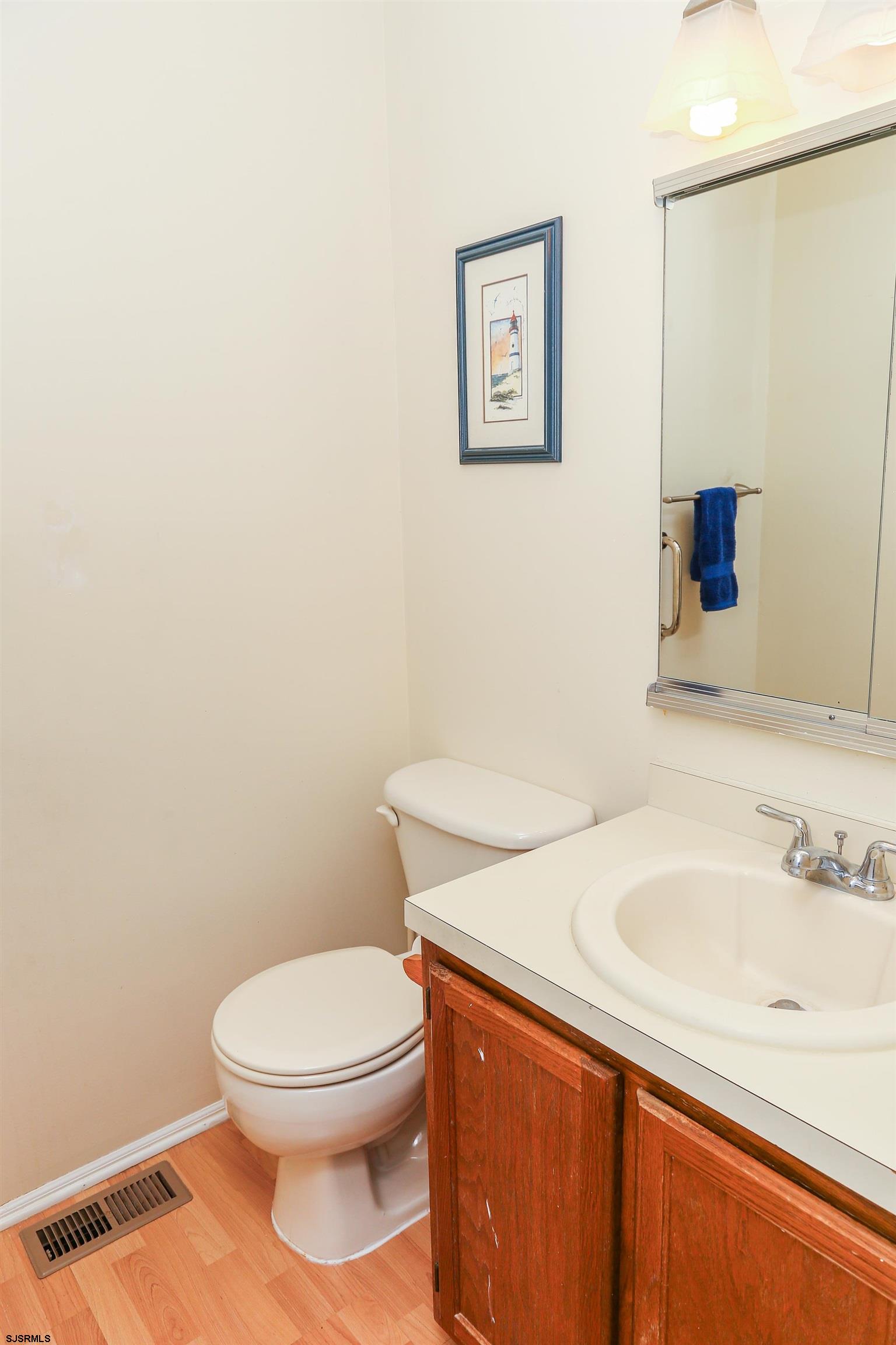 340 Seashell Lane Brigantine, NJ 08203 - Photo 21 of 29 a bathroom with a toilet a sink and mirror