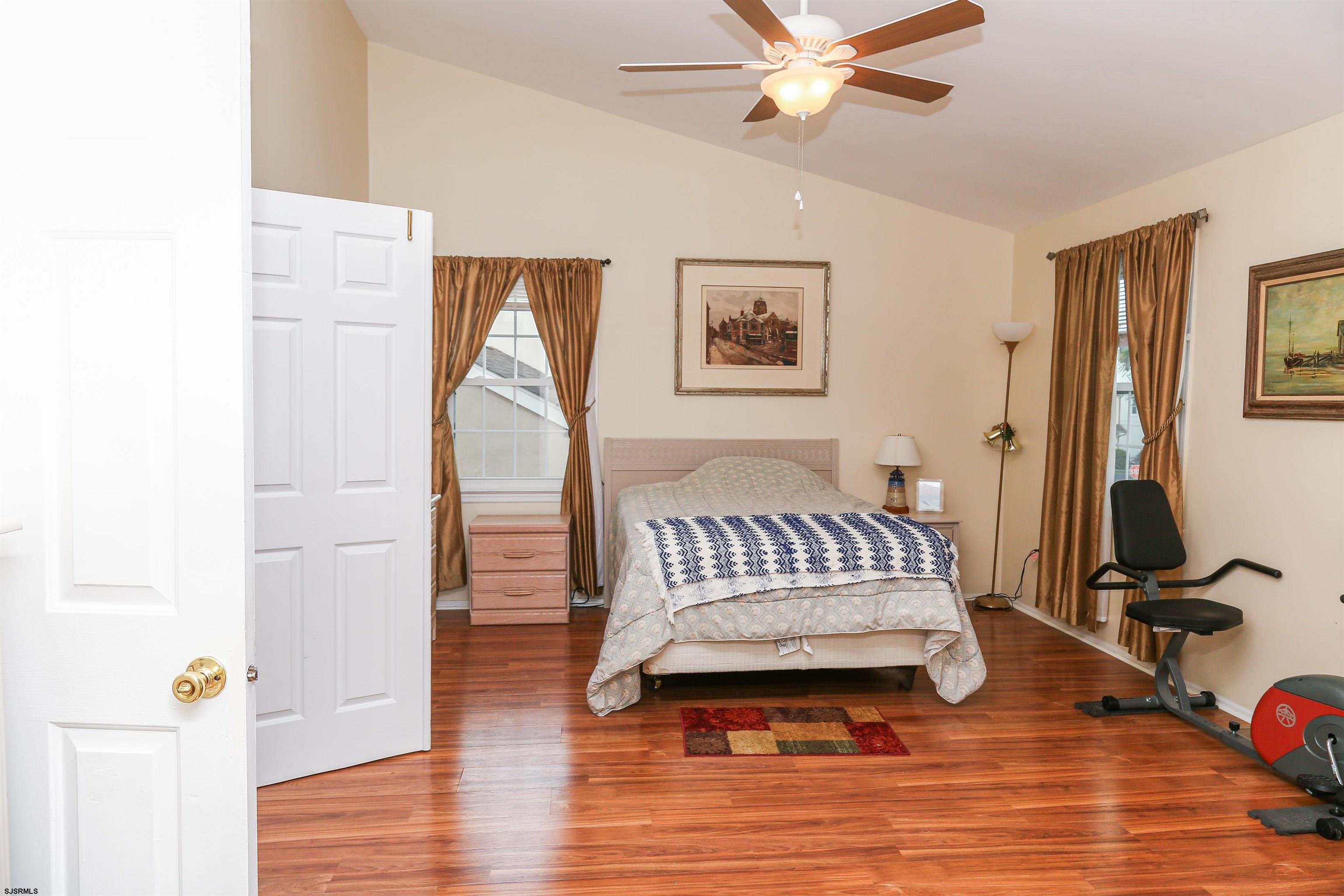 340 Seashell Lane Brigantine, NJ 08203 - Photo 23 of 29 a bedroom with a bed and wooden floor