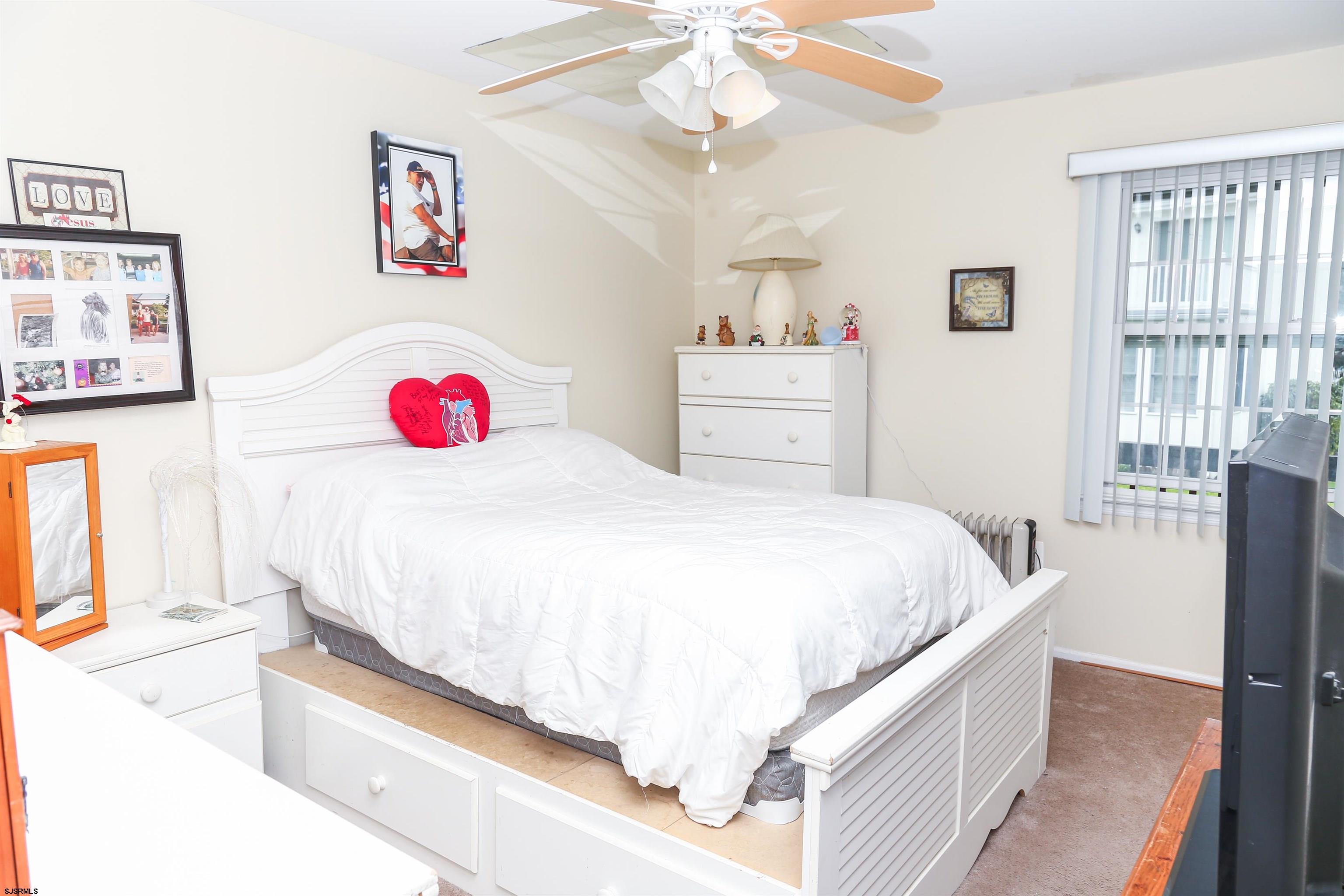 340 Seashell Lane Brigantine, NJ 08203 - Photo 7 of 29 a bed room with a bed and a chandelier