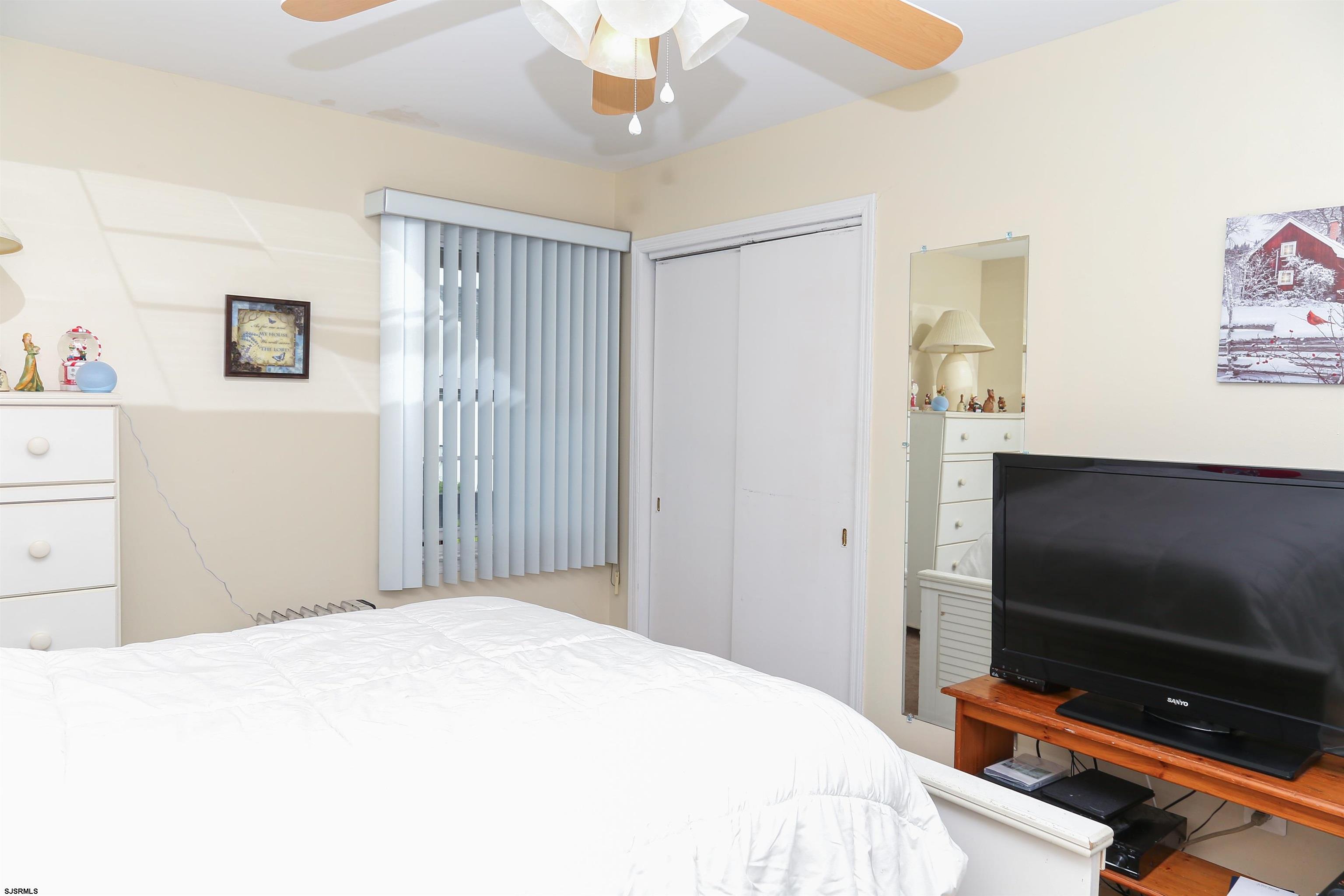 340 Seashell Lane Brigantine, NJ 08203 - Photo 8 of 29 a bedroom with a bed and a flat screen tv