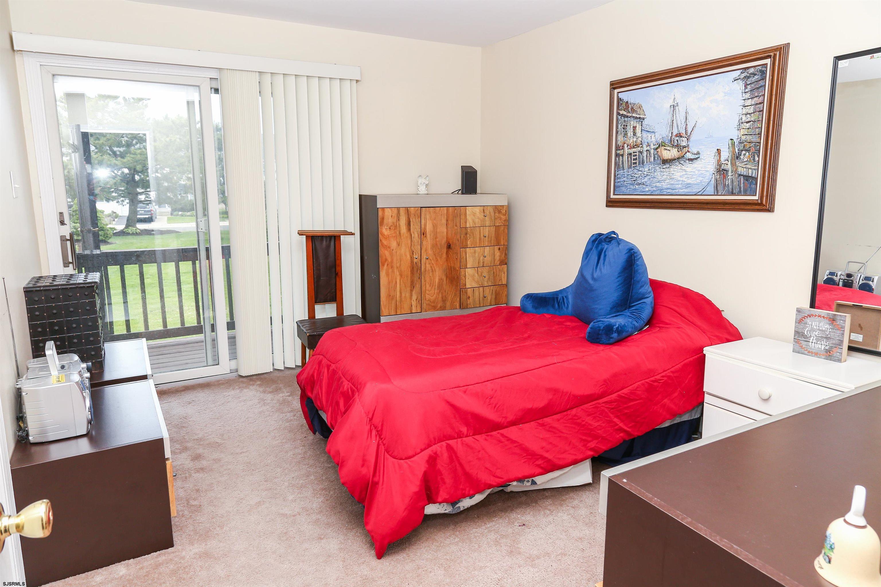 340 Seashell Lane Brigantine, NJ 08203 - Photo 10 of 29 a bedroom with a bed and wooden floor