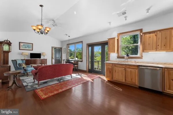 a kitchen with stainless steel appliances granite countertop a sink a stove and a wooden cabinets