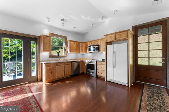 a kitchen with wooden cabinets and stainless steel appliances