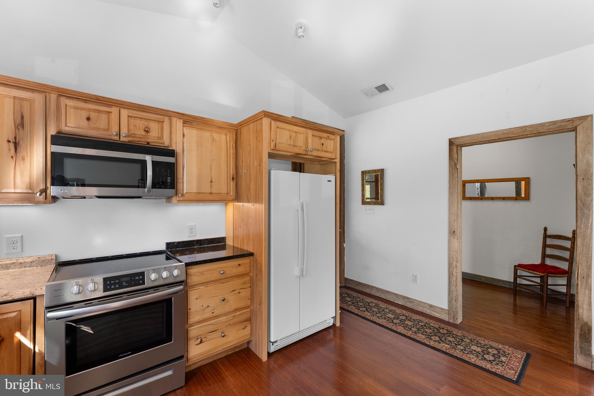 439 Rudasill Mill Road Woodville, VA 22749 - Photo 26 of 48 a kitchen with wooden cabinets and stainless steel appliances