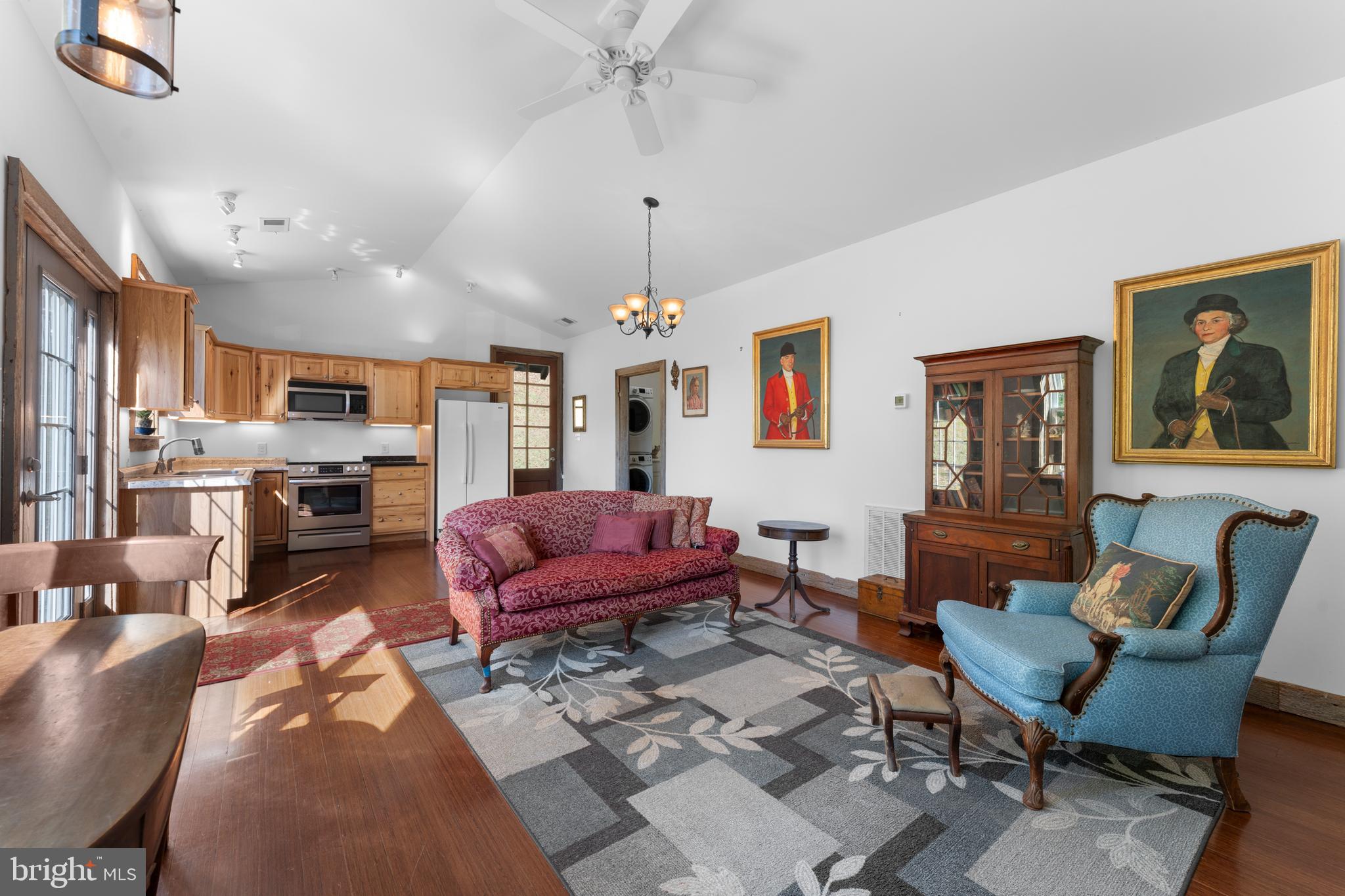 439 Rudasill Mill Road Woodville, VA 22749 - Photo 29 of 48 a living room with furniture kitchen view and a chandelier