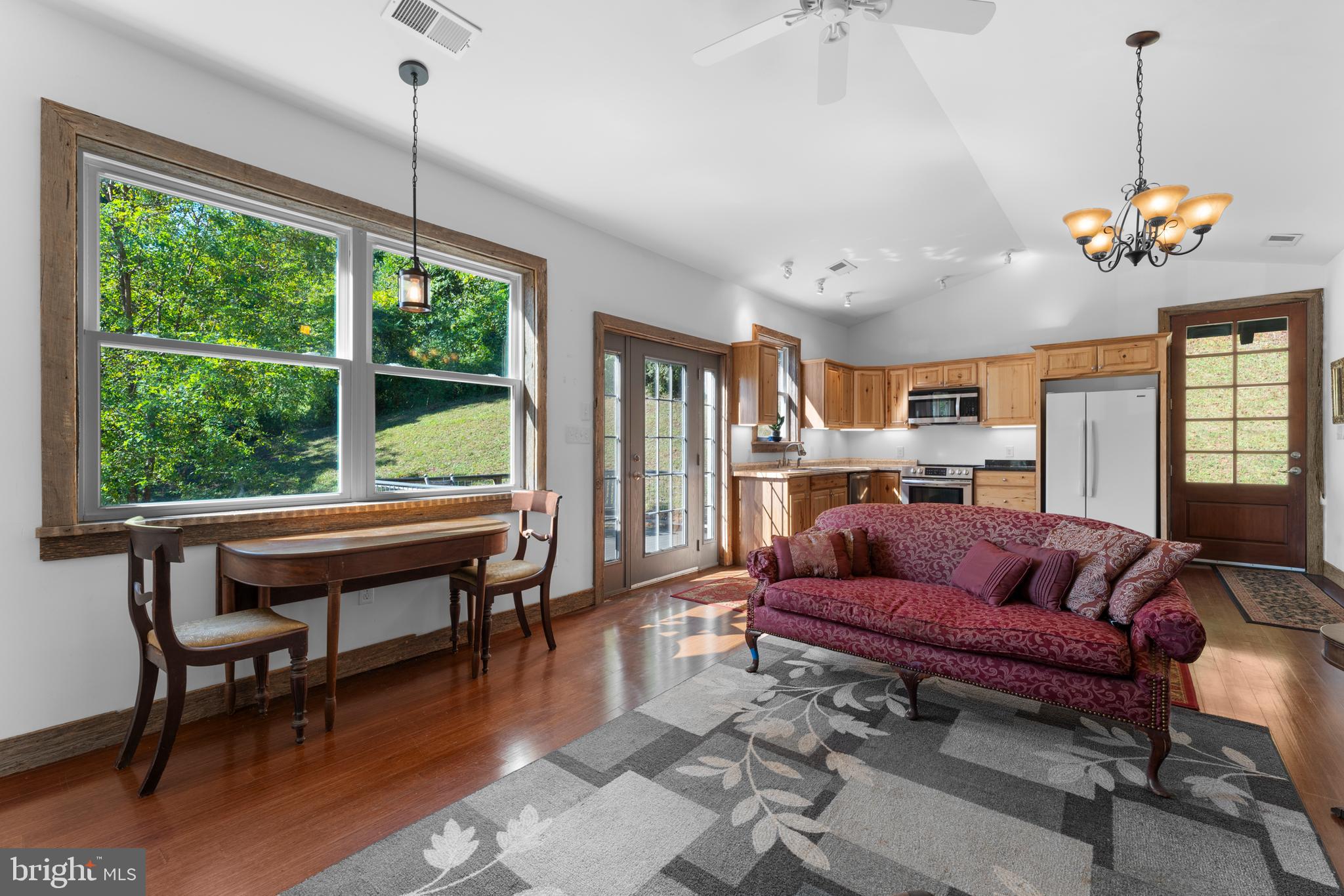 439 Rudasill Mill Road Woodville, VA 22749 - Photo 30 of 48 a living room with furniture a window and a chandelier