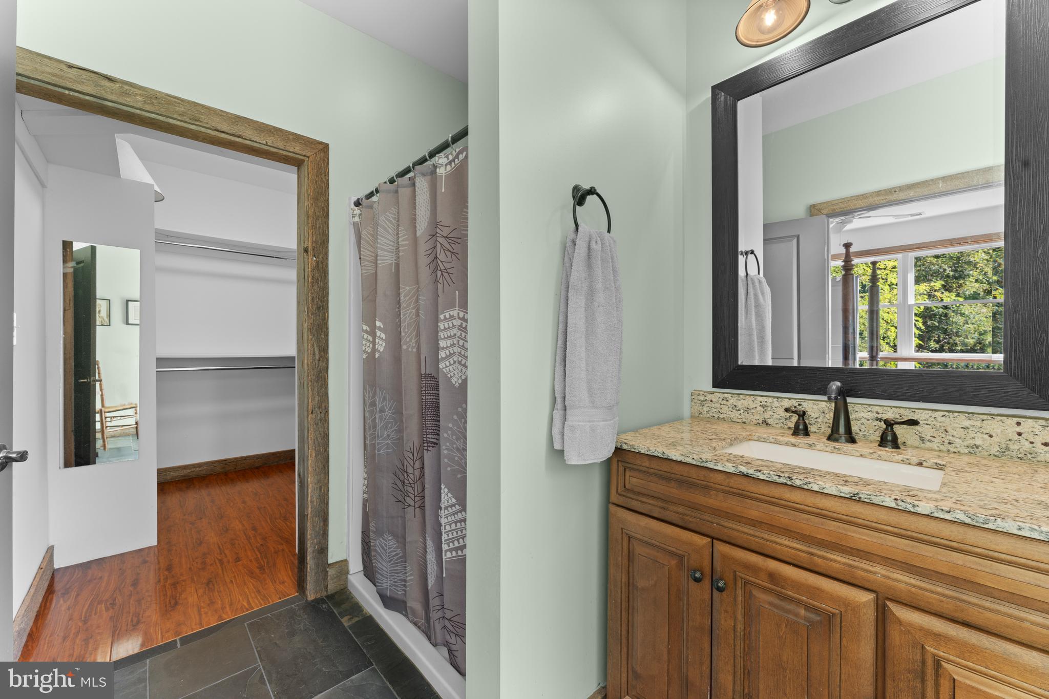 439 Rudasill Mill Road Woodville, VA 22749 - Photo 36 of 48 a bathroom with a granite countertop sink and a mirror
