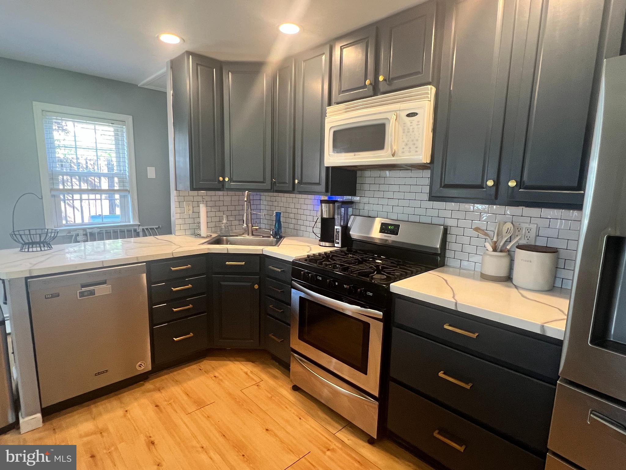 1075 Haverford Road Ridley Park, PA 19078 - Photo 4 of 14 a kitchen with a sink stove and cabinets