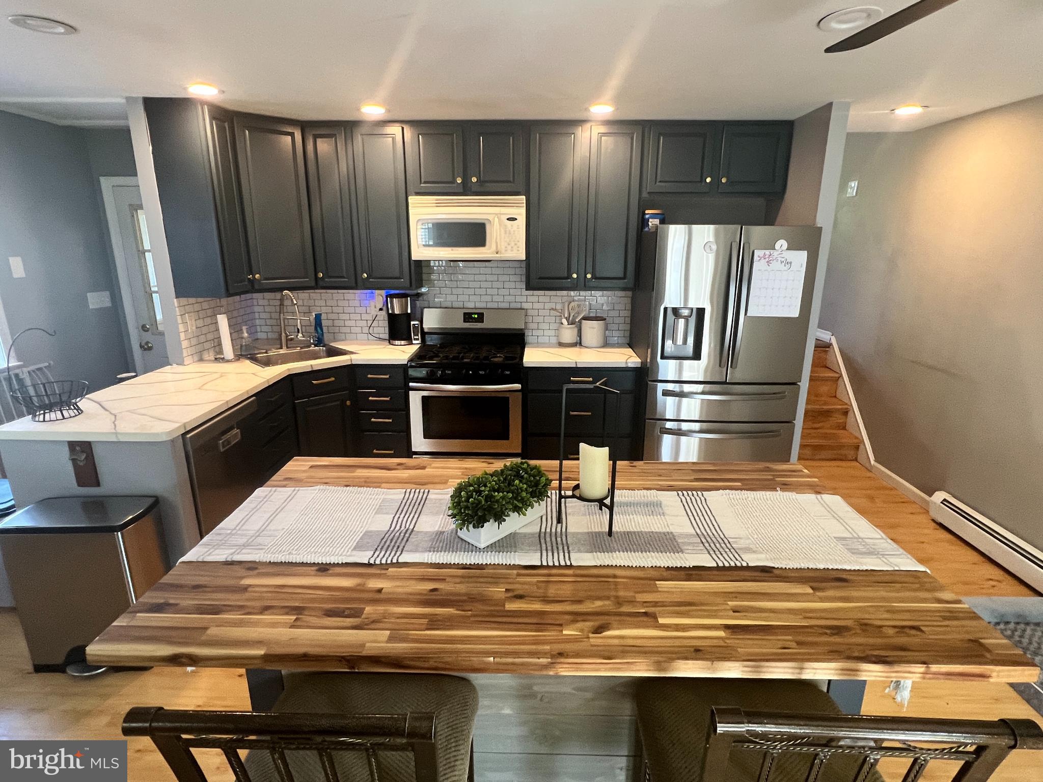 1075 Haverford Road Ridley Park, PA 19078 - Photo 6 of 14 a kitchen with stainless steel appliances kitchen island granite countertop a sink refrigerator and cabinets