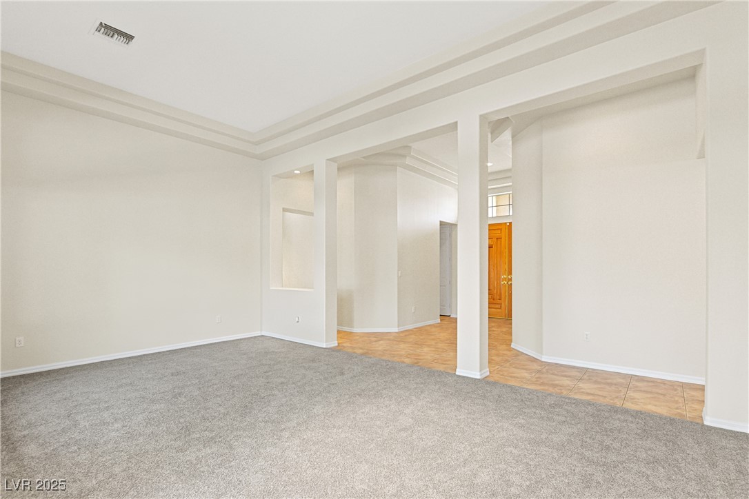 10548 Findlay Avenue Las Vegas, NV 89134 - Photo 8 of 27 Unfurnished room featuring light colored carpet and light tile patterned floors
