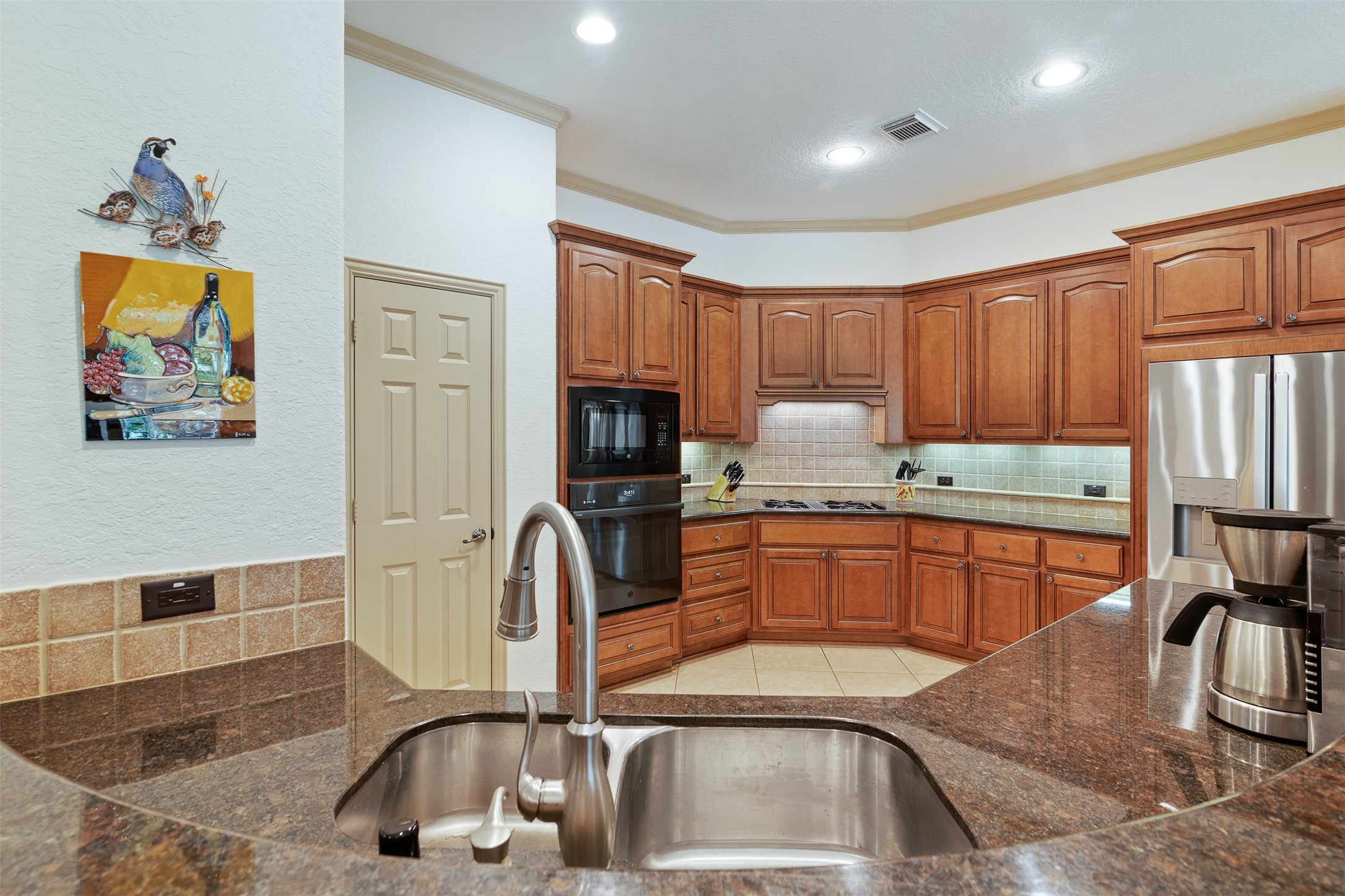 19507 Remington Manor Street Spring, TX 77379 - Photo 11 of 33 Kitchen has recessed canned lighting and crown molding.