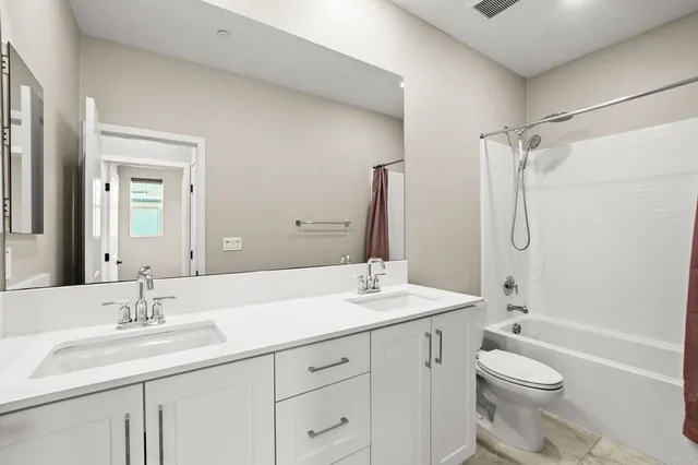 a front view of multi story residential apartment building with yard and green space