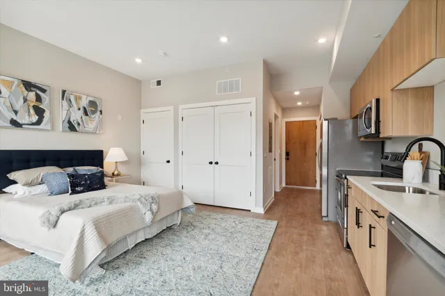 a bedroom with a large bed and painting on the wall