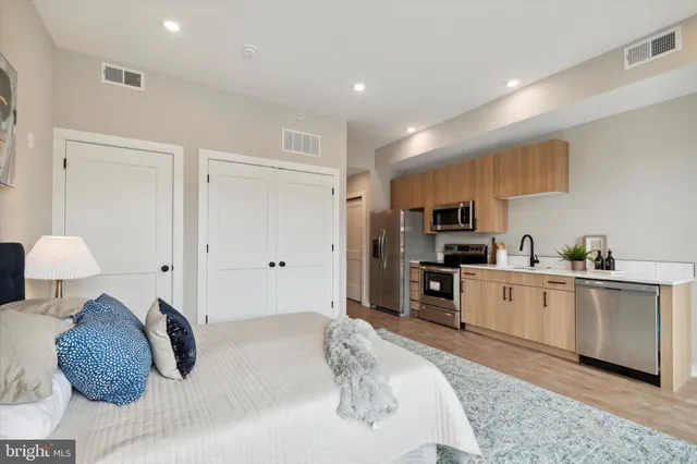 a bedroom with a bed and a large mirror