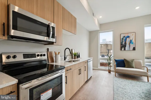 a kitchen with stainless steel appliances a stove microwave and cabinets