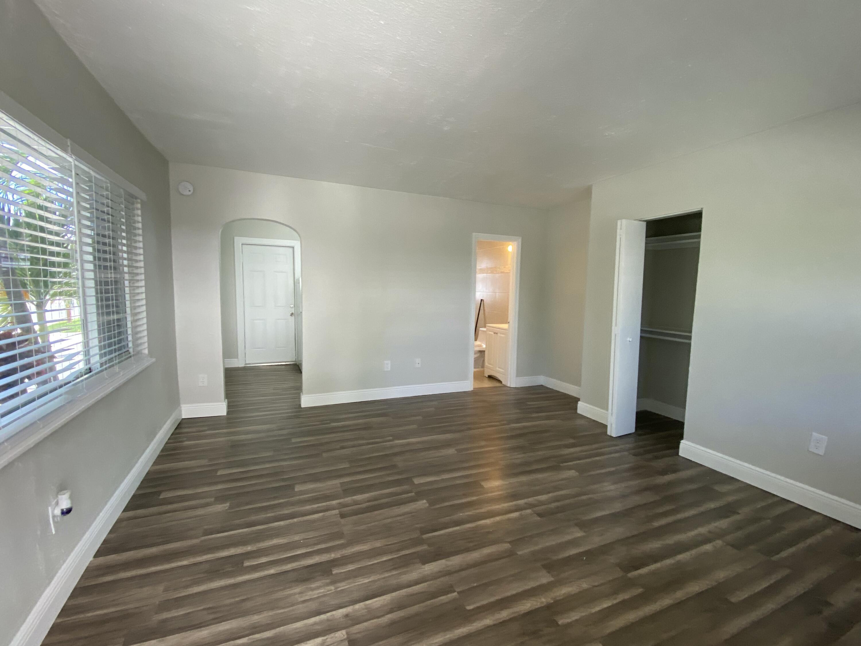 605 North Federal Highway, Unit 1 Lake Worth Beach, FL 33460 - Photo 3 of 9 a view of an empty room with wooden floor and a window