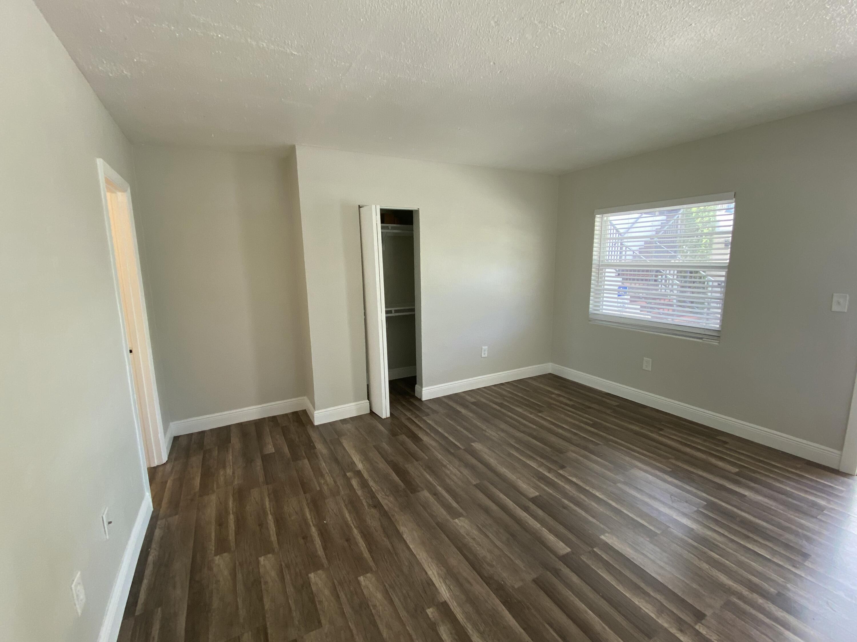 605 North Federal Highway, Unit 1 Lake Worth Beach, FL 33460 - Photo 6 of 9 an empty room with wooden floor and windows