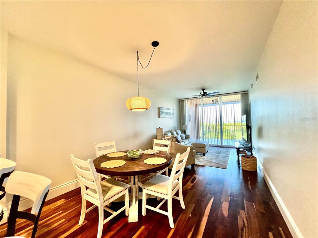 3191 Matecumbe Key Road, Unit 206 Punta Gorda, FL 33955 - Photo 15 of 45 a view of a dining room with furniture and wooden floor