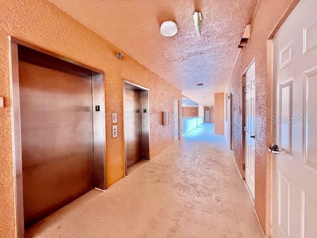 3191 Matecumbe Key Road, Unit 206 Punta Gorda, FL 33955 - Photo 26 of 45 a view of a hallway with wooden shelves