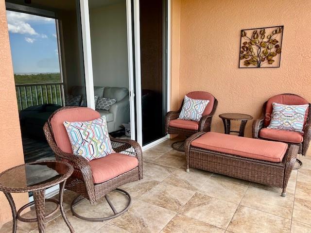 3191 Matecumbe Key Road, Unit 206 Punta Gorda, FL 33955 - Photo 7 of 45 a bedroom with a bed a couch and dresser