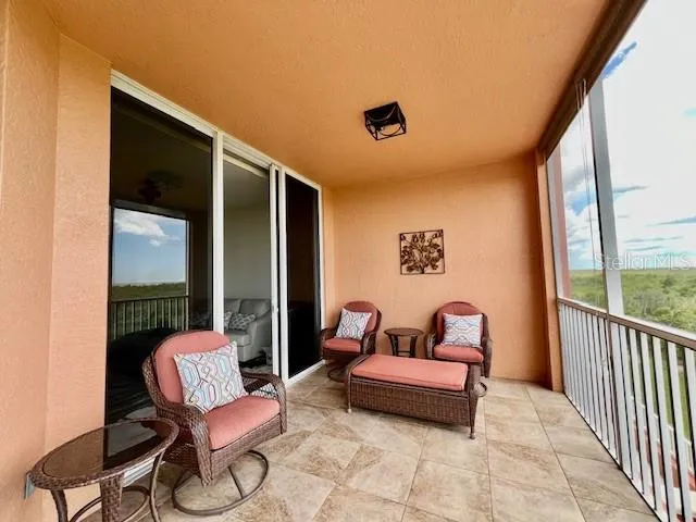 a view of a balcony with a yard