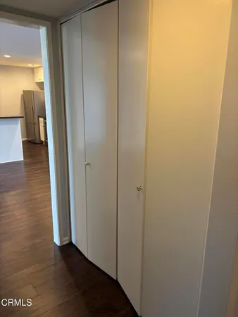 a view of a water heater room with wooden floor