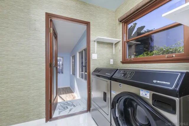a bathroom with a granite countertop sink a bathtub and mirror