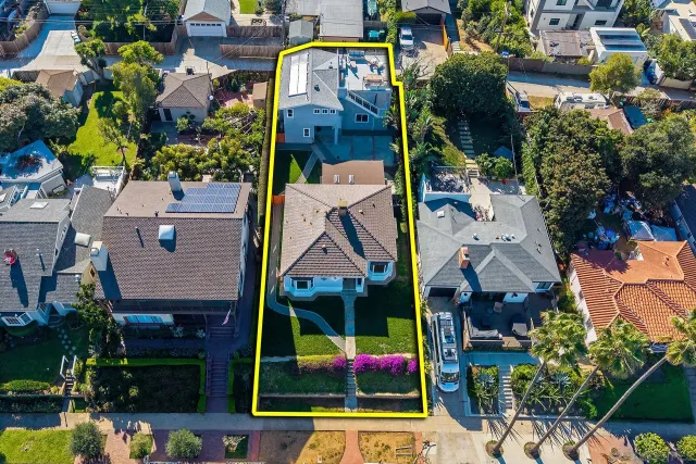 an aerial view of a house with a yard
