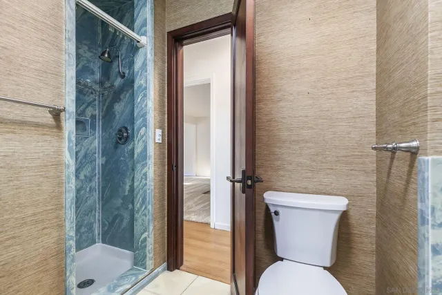 a bathroom with a toilet sink and shower