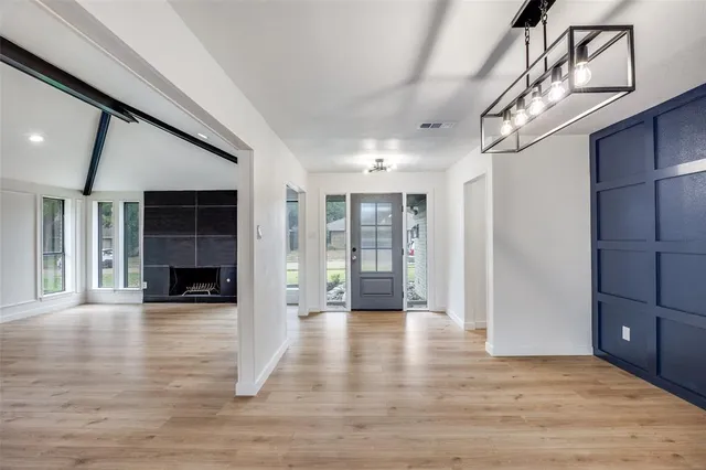 a view of a livingroom with wooden floor and stairs