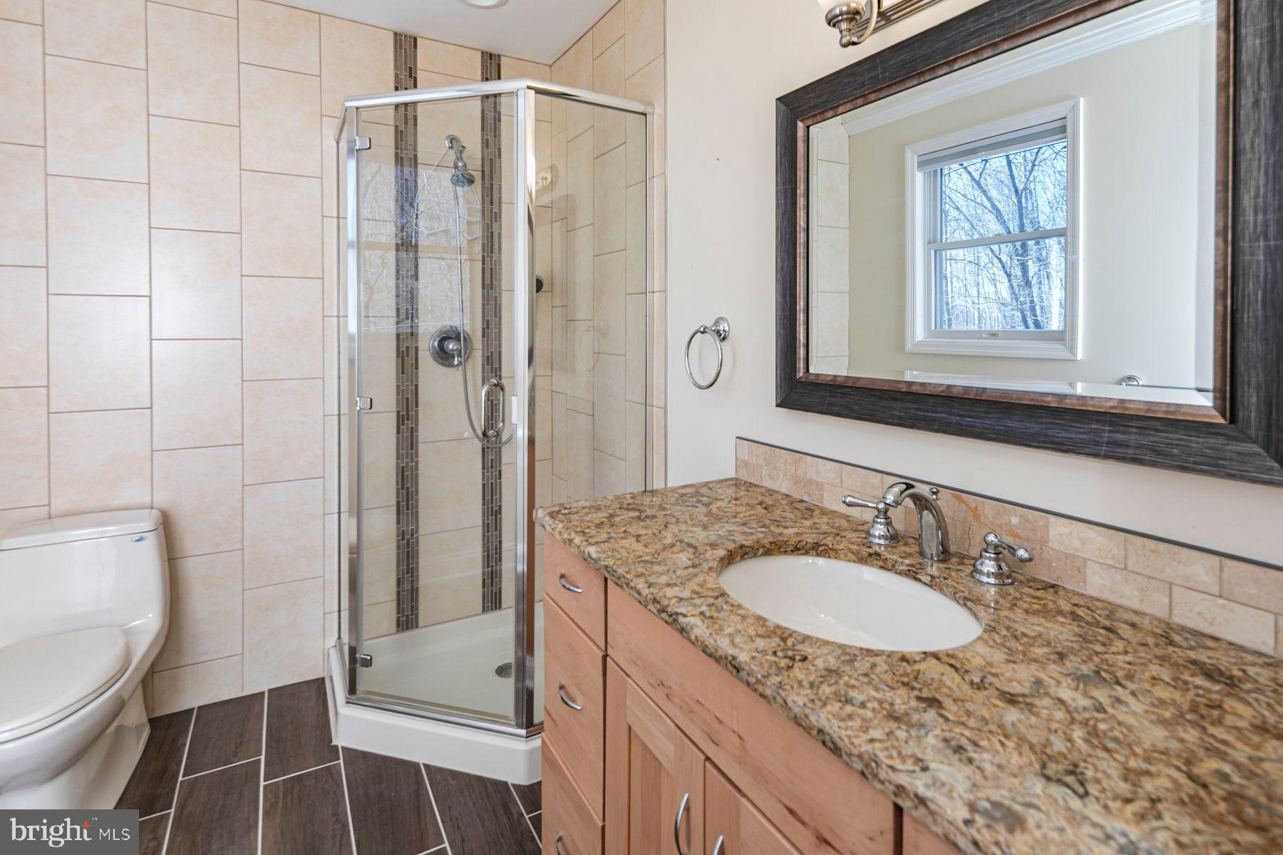 310 Hollow Road Skillman, NJ 08558 - Photo 24 of 32 a bathroom with a granite countertop sink toilet and shower